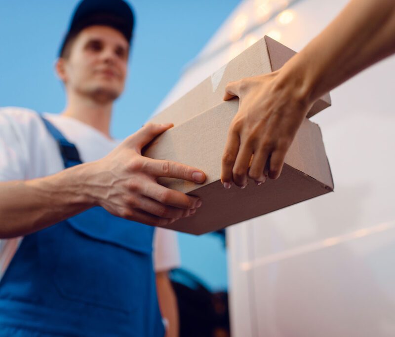 deliveryman-gives-parcel-to-female-recipient-2021-08-27-09-54-31-utc-1024x683